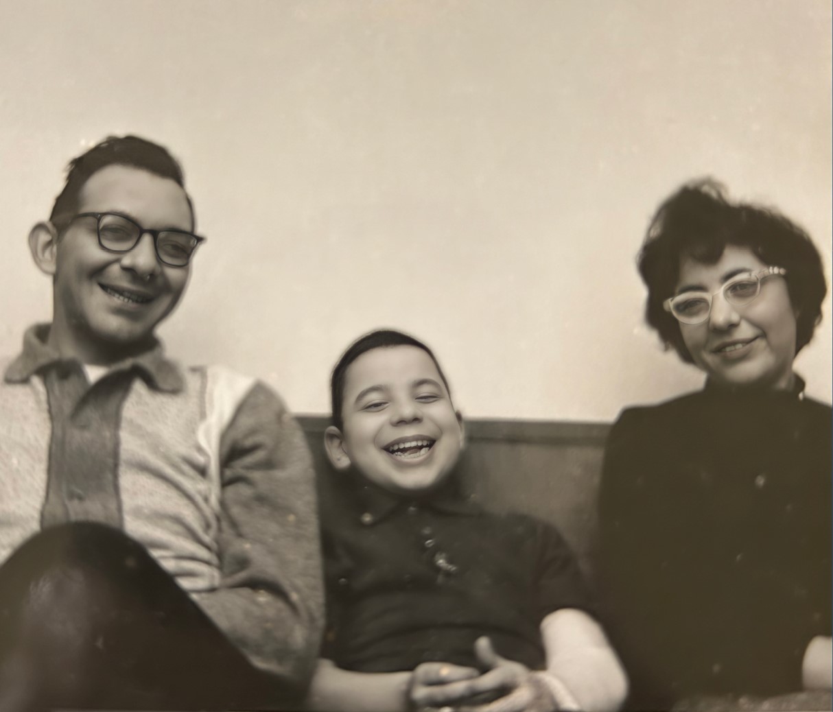 A sepia photo of Dr. Winer as a child with his parents.