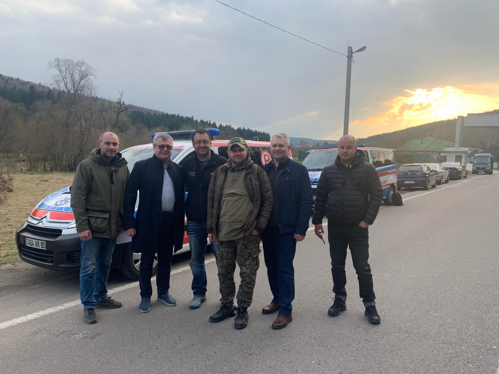 Group photo including Dr. Bratslavsky and the ambulances delivered to Lviv.