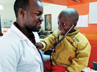 Dr. Fidel Rubagumya and a young patient with cancer at the Butaro Cancer Center of Excellence
