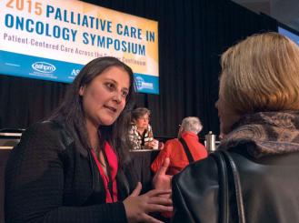 Areej El-Jawahri, MD, chats with an attendee during General Session 1: Improving Communication—Best Practices and Novel Tools.