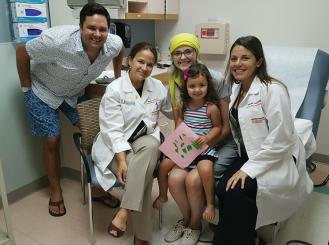 Ms. Sullivan (center) and Dr. Wilky (second from left), with Ms. Sullivan’s family and Dr. Wilky’s colleague at the University of Miami.