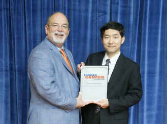 Jianjun Zhang, MD, PhD, with W. Charles Penley, MD, FASCO, Conquer Cancer Past Chair  
