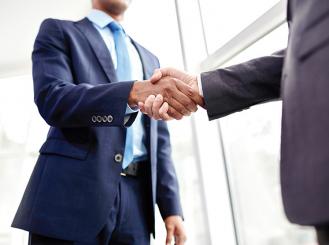 Stock image of two professionals shaking hands