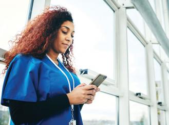 A physician looks at her smartphone