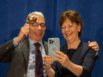 Dr. Eric P. Winer and Dr. Lynn M. Schuchter taking a selfie as they pass the presidential gavel.