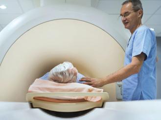 Stock image of MRI technician with patient