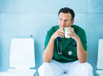 Stock image of a doctor or nurse drinking coffee