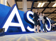 Group posed in front of ASCO sign