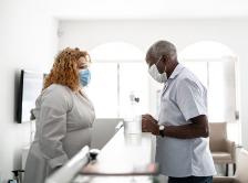 stock photo of Black medical professional and patient in medical office