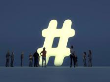 crowd gathered around a super-sized hashtag