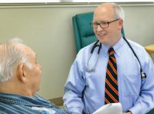 Photo of Dr. David M. Waterhouse with an elderly male patient